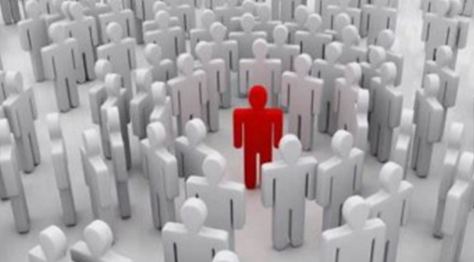 A red figure stands out among a crowd of gray figures.
